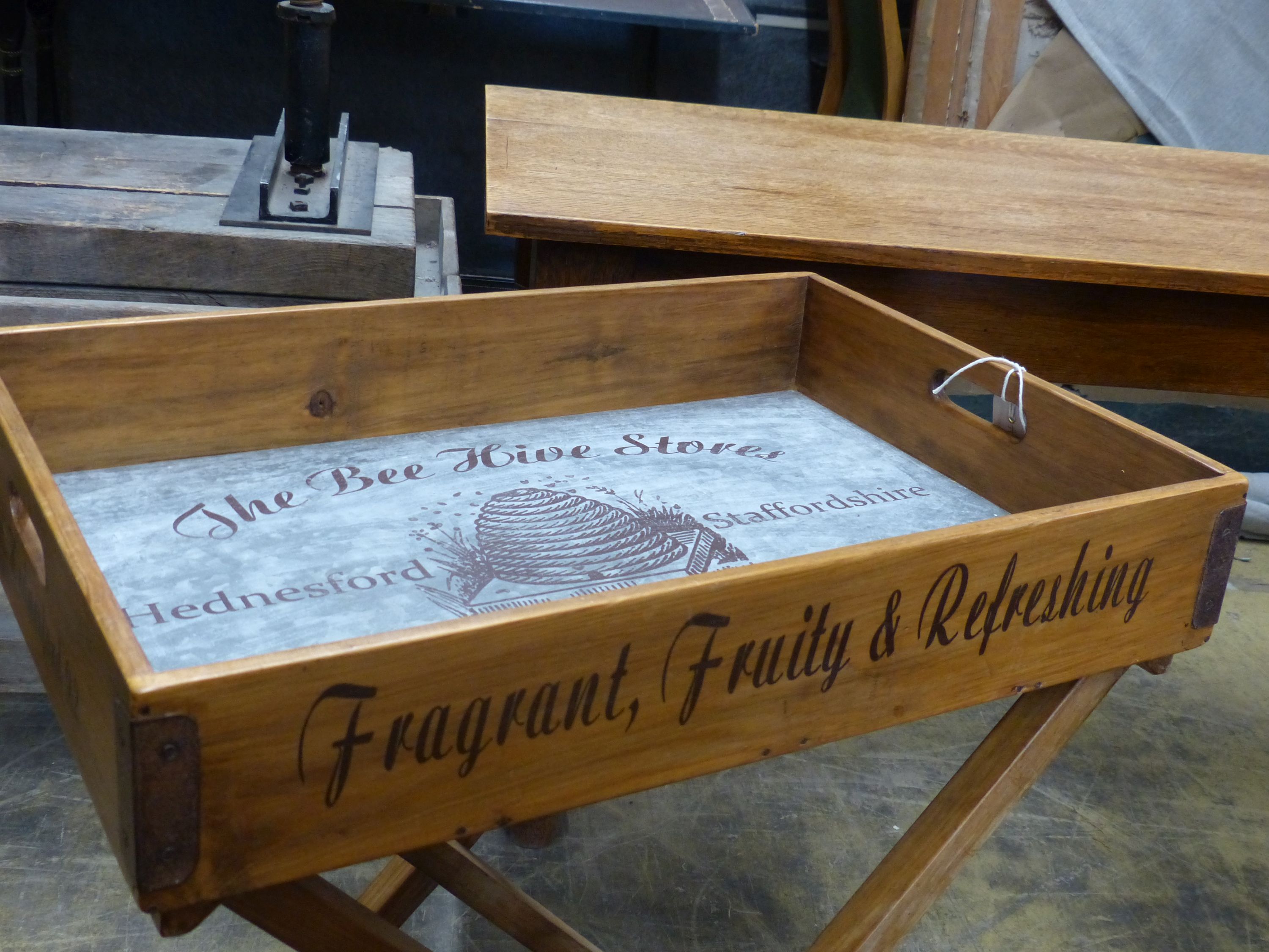 'The Bee Hive Stores', a rectangular wooden produce display tray on folding stand, width 65cm, depth 44cm, height 78cm